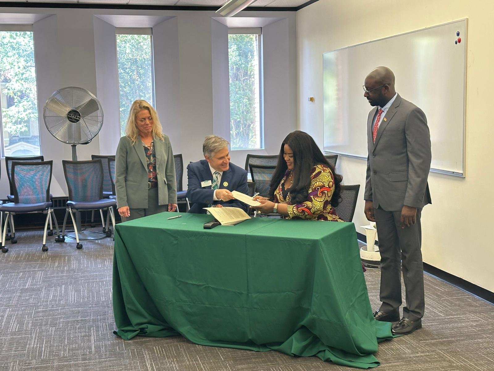 Representatives reviewing the signed MOU documents at the table